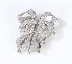 A diamond set double clip brooch, each clip set with brilliant and baguette cut diamonds, with