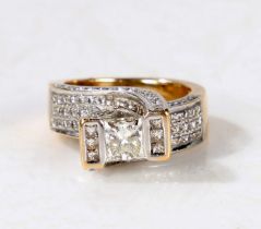 An 18 carat gold and diamond ring, the head set with a central princess cut diamond estimated at 0.
