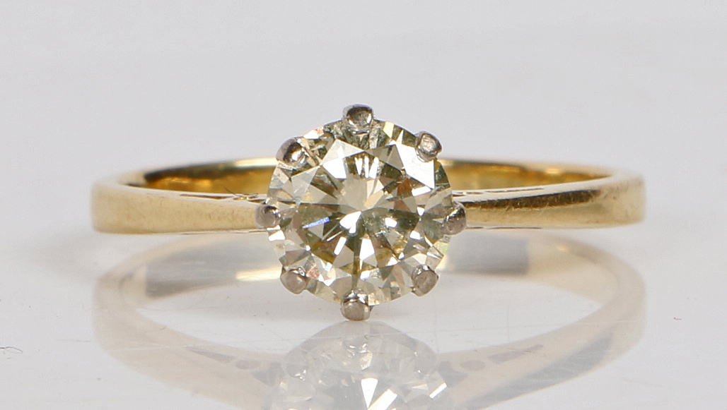 An 18 carat gold solitaire ring, the round brilliant cut diamond at approximately 1ct. ring size