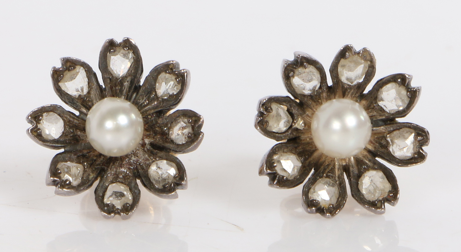 A pair of rose cut diamond and pearl earrings, of flower head form, the central pearls with eight