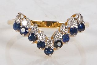 An 18 carat gold, sapphire and diamond ring, the V shaped head set with nine round cut sapphires and