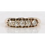 An 18 carat gold ring set with five graduated diamonds, the central stone measuring 3.4mm