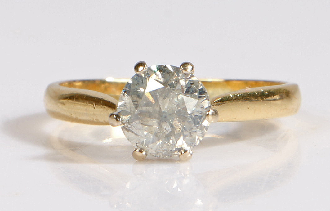 An 18 carat gold diamond solitaire ring, the diamond at 1.50 carat within six claws, ring size P