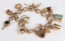 A 9 carat gold charm bracelet, with heart form clasp and set with various 9 carat gold charms to