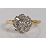 A yellow metal, platinum and diamond ring, the head set with a central round diamond surrounded by a