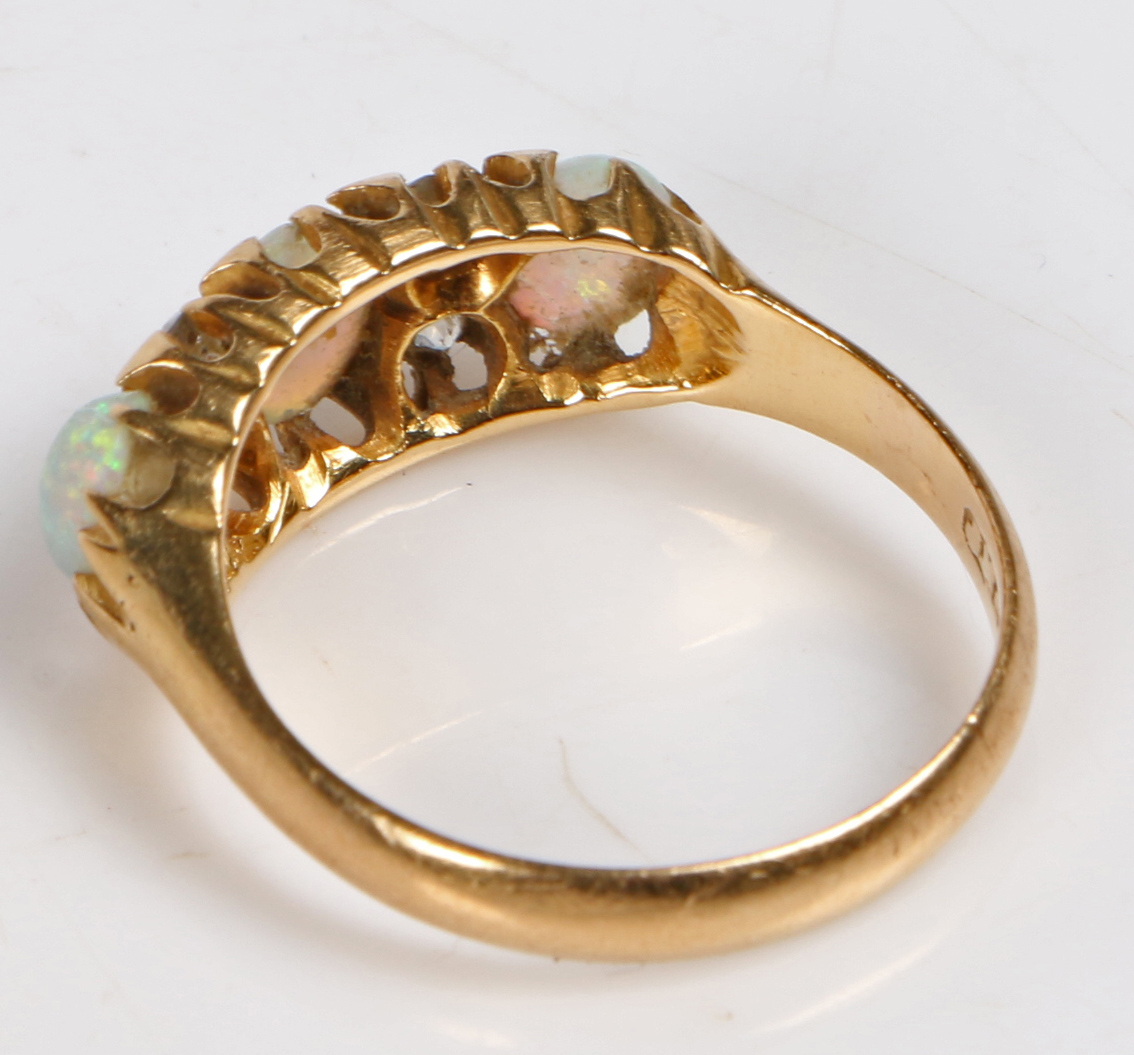 An 18 carat gold, opal and diamond ring, the head set with three oval opals interspersed by four - Bild 2 aus 3