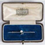 An Edwardian yellow and white metal bar brooch, the bar with central stylised branch set with a