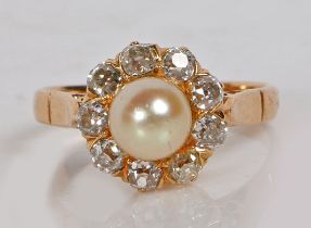 A yellow metal pearl and diamond ring, with central pearl surrounded by nine diamonds, the pearl