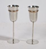 A pair of Cartier silver flutes, the bowls with tri-colour banded decoration, on slender stems and