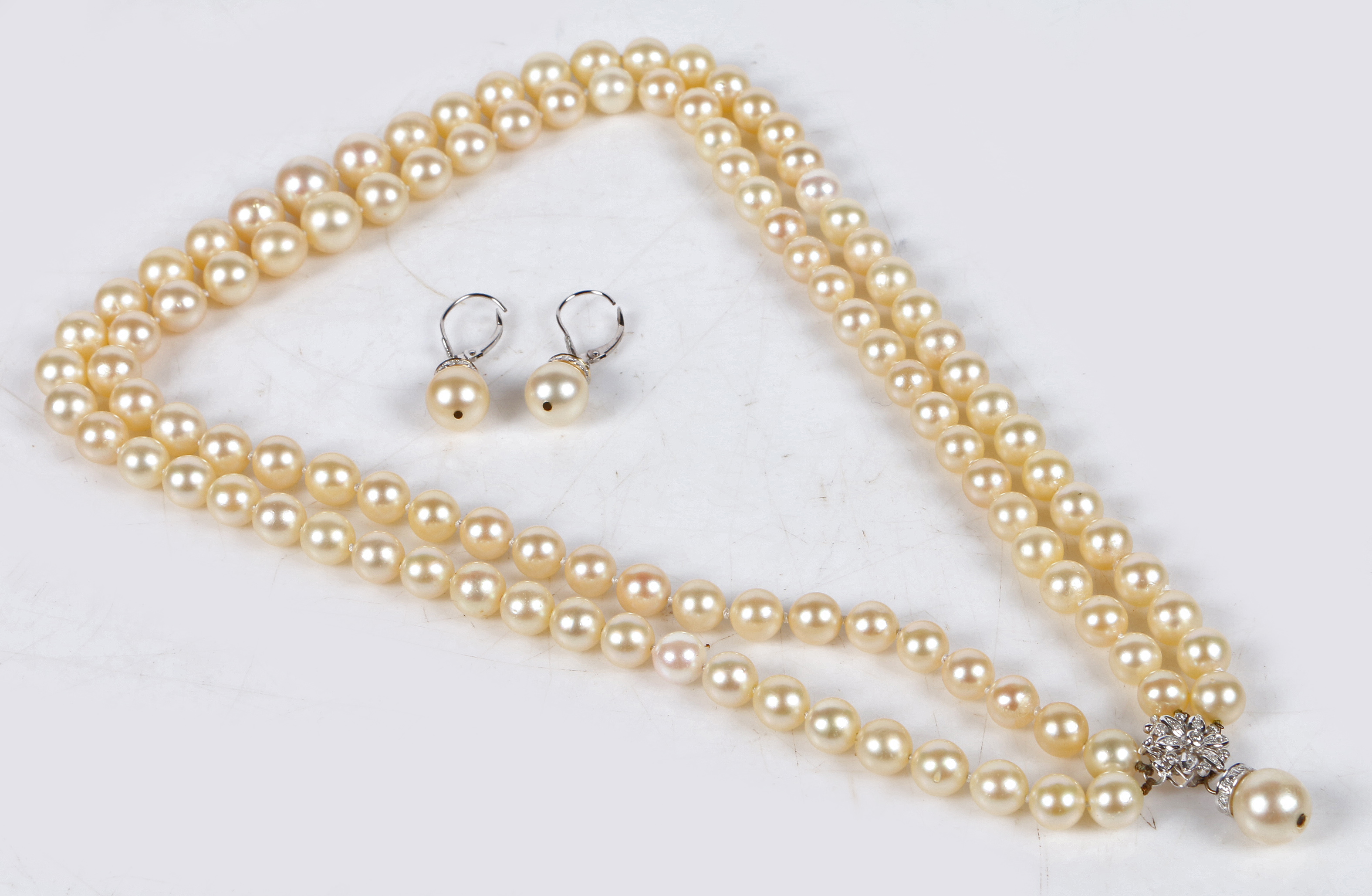 A cultured pearl necklace, formed from two rows of graduated pearls terminating in a 14 carat