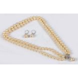 A cultured pearl necklace, formed from two rows of graduated pearls terminating in a 14 carat