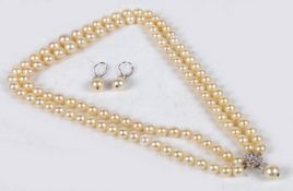 A cultured pearl necklace, formed from two rows of graduated pearls terminating in a 14 carat