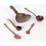 A collection of treen to include a spoon with large flattened bowl, a spoon with wheat sheaf