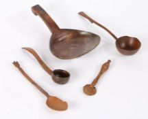 A collection of treen to include a spoon with large flattened bowl, a spoon with wheat sheaf
