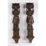 Two 17th century carved columns, each depicting a lady holding aloft an ionic capital above