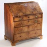 A George III mahogany bureau, the rectangular top above a sloping fall enclosing a series of