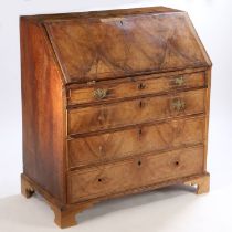 A George III mahogany bureau, the rectangular top above a sloping fall enclosing a series of