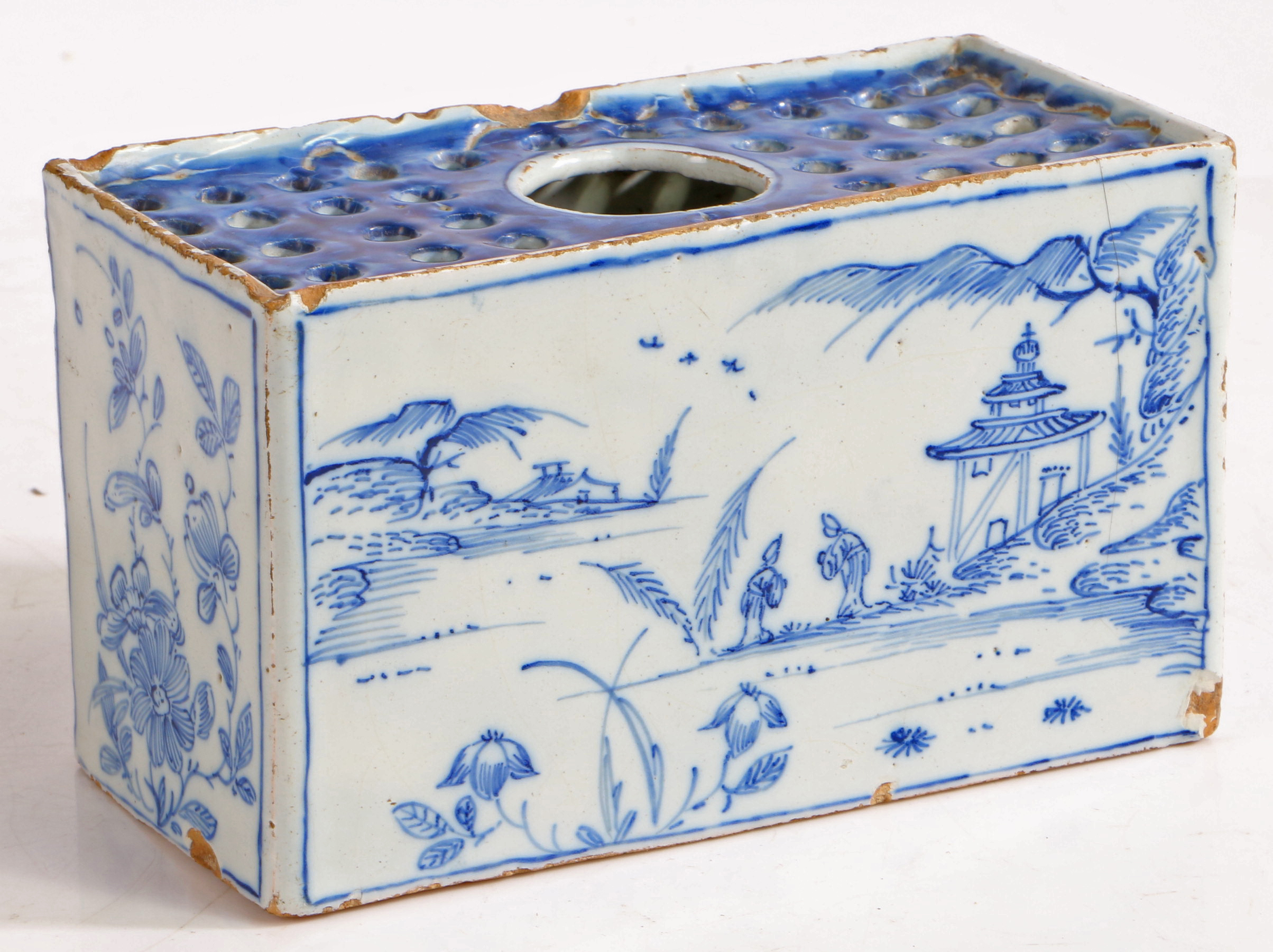 An 18th Century Delft flower brick, with Oriental landscape decorated front and back flanked by