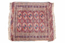 A Tekke Turkoman rug, having a red and blue ground set with two rows of guls together with a