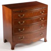 A Regency style mahogany and boxwood strung bow front chest, the boxwood inlaid bow top above a