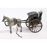 A folk art horse and hansom cab, the dappled grey painted horse pulling the black cab, 24cm wide (