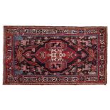 An Iranian rug, having a red and brown ground set with central motif set with animals and people,