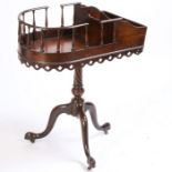 A George III style mahogany butlers stand, with a galleried and tray sectional top above a turned