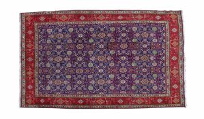 A Large Iranian rug, having a blue ground set with floral guls together with multiple repeating