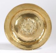 A 17th Century brass alms dish, Nuremberg, the centre embossed with twelve repeating gadroons,