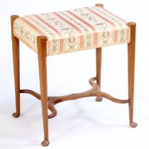 An Art Nouveau early 20th Century mahogany and boxwood inlaid foot stool, the stuff over seat