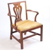 A George III mahogany armchair, of large proportions, the arched top rail above a pierced splat