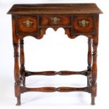An 18th Century oak side table/ dressing table, of small proportions, the rectangular top above