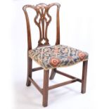 A George III mahogany chair, the arched top rail above a pierced splat and serpentine seat raised on
