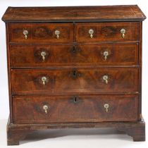 A George II walnut chest of drawers, the rectangular cross banded and box wood strung top above