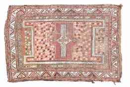 A Baluch rug, the red ground set with a with a central hooked gul together with multiple repeating