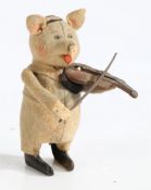 A Schuco clockwork toy pig, modelled playing a violin, with key, 11cm high