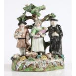 A 19th Century Staffordshire bocage "Tithe Pig" group, modelled as a farmer, his wife and baby