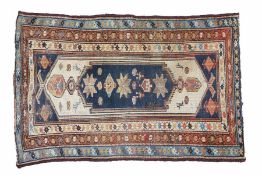 A Caucasian rug, having a central field set with stars and rosettes together with floral vine