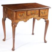 A George III fruitwood lowboy, the rectangular feather banded top with quarter panel veneers above