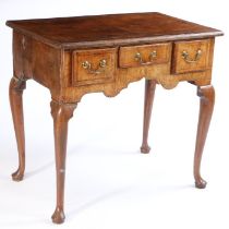 A George III fruitwood lowboy, the rectangular feather banded top with quarter panel veneers above