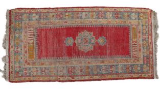 A South Persian rug, having a red and blue ground set with a central medallion together with