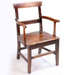 A George III fruitwood and oak elbow chair, the bar above above curved arms and solid seat raised on