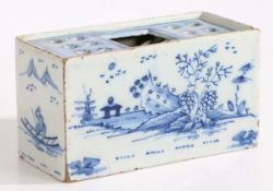 An 18th Century Delft flower brick, with Oriental landscape decorated front and back flanked by a