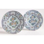 A pair of 18th Century Delft plates, possibly Bristol, circa 1750, with polychrome foliate