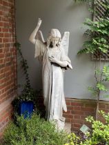 A late 19th Century carved marble angel, with one arm raised, the other across the chest, the head