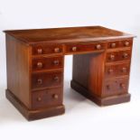 A Victorian mahogany desk, the rectangular top above nine drawers to the kneehole and plinth base,
