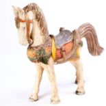 Rajasthan type carved horse, painted in white, red, green and brown, 88cm long, 83cm high
