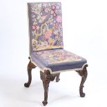 A mahogany single chair, in the George III taste, the tapestry back and seat above foliate carved