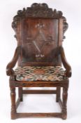 A 17th Century and later oak wainscot, Yorkshire, with a scroll carved arching crest above a diamond