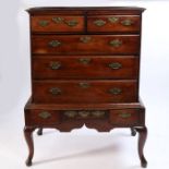 A George III mahogany chest on stand, the mahogany top above two short and three long drawers raised